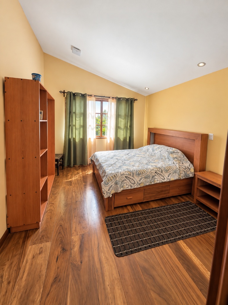Master bedroom with wardrobe and green curtains